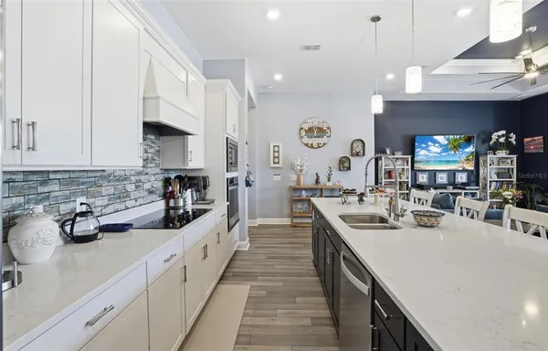 a view of a patio with a table and chairs under an umbrella
