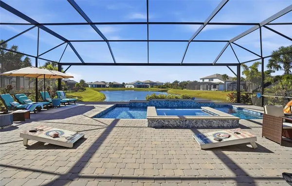 a view of deck and patio with table and chairs under an umbrella