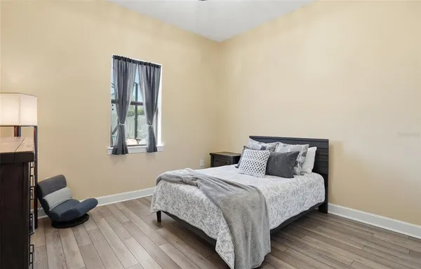 a bedroom with a bed and a dresser in it