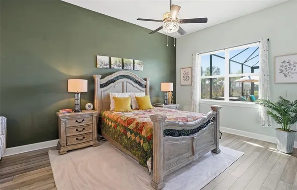 a view of a swimming pool with a table and chairs under an umbrella