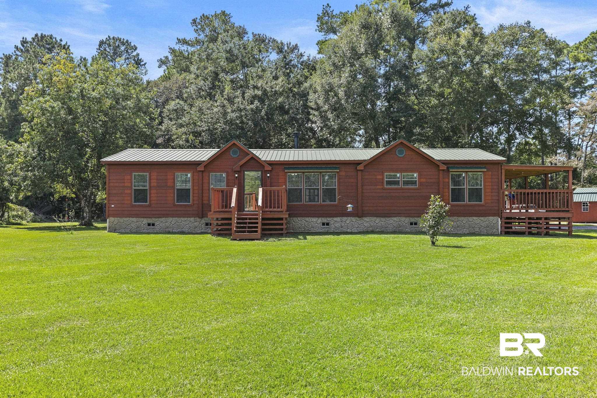 35641 County Road 39 Stapleton, AL 36578 - Photo 1 of 46 View of front facade featuring a wooden deck and a front yard