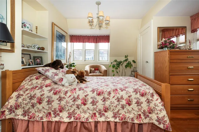 a bedroom with a large bed and a dresser