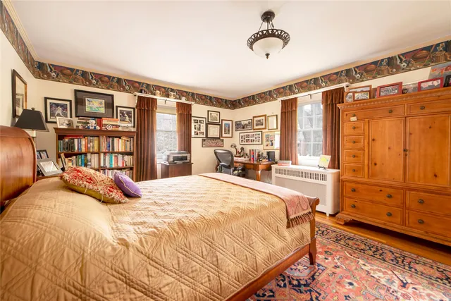 a bedroom with a bed next to a window