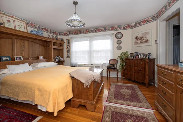 a spacious bedroom with a bed and a dresser