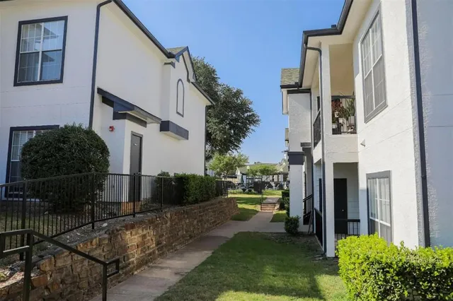a kitchen with appliances a sink and cabinets