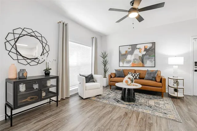 a living room with furniture and a wooden floor