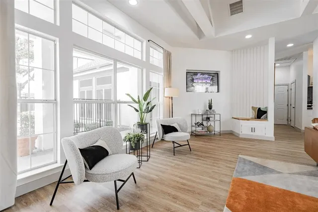 a living room with furniture and wooden floors