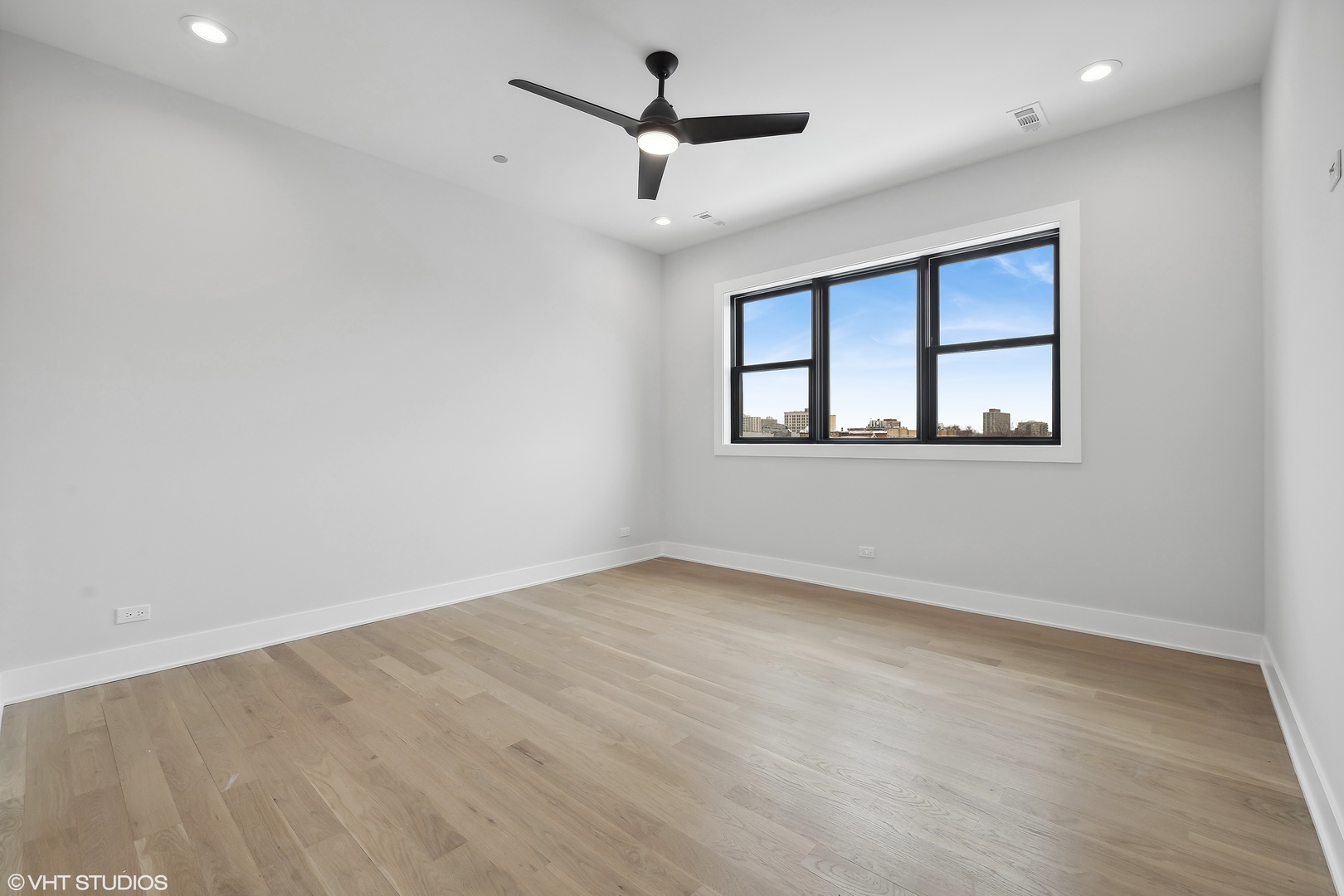4537 North Clark Street, Unit 4D Chicago, IL 60640 - Photo 13 of 29 an empty room with a window and a ceiling fan