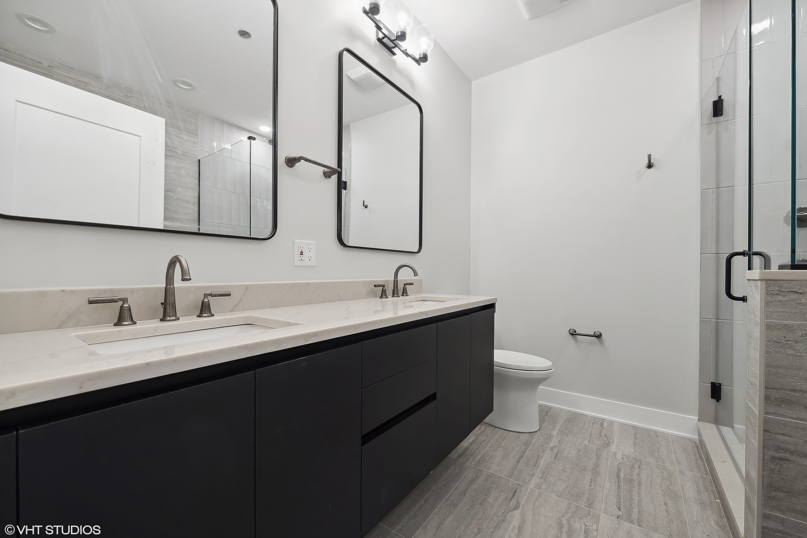 4537 North Clark Street, Unit 4D Chicago, IL 60640 - Photo 14 of 29 a bathroom with a double vanity sink and mirror