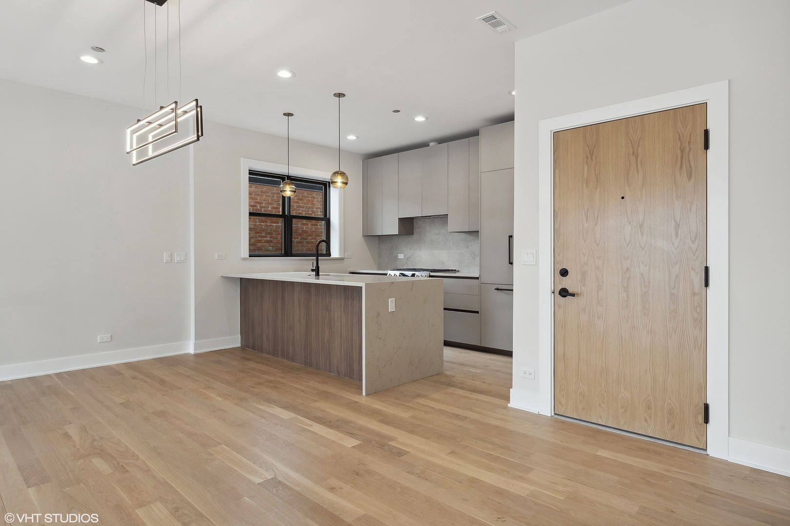 4537 North Clark Street, Unit 4D Chicago, IL 60640 - Photo 3 of 29 a kitchen with stainless steel appliances kitchen island granite countertop a refrigerator and a sink
