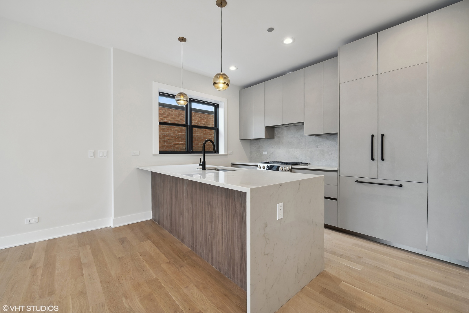 4537 North Clark Street, Unit 4D Chicago, IL 60640 - Photo 4 of 29 a kitchen with kitchen island a sink stainless steel appliances and cabinets