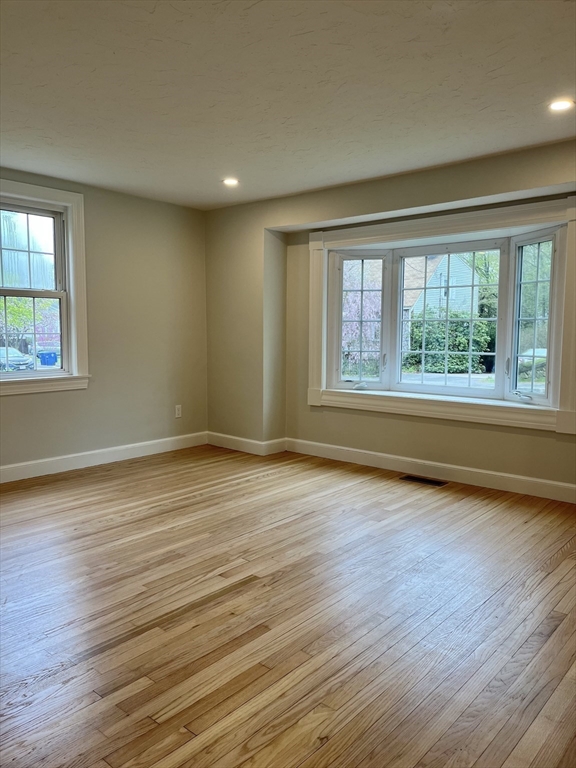 69 Brookside Road Braintree, MA 02184 - Photo 12 of 28 an empty room with wooden floor and windows