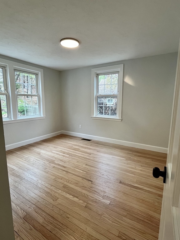 69 Brookside Road Braintree, MA 02184 - Photo 14 of 28 an empty room with wooden floor and windows