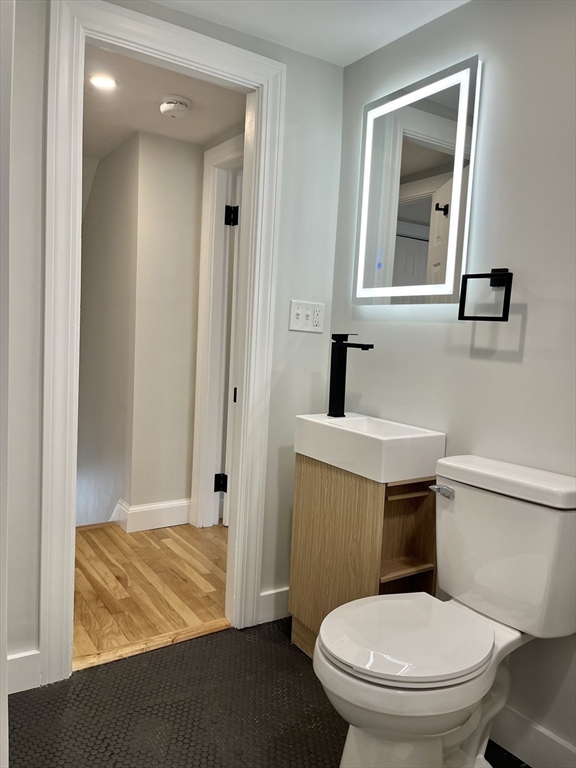 69 Brookside Road Braintree, MA 02184 - Photo 15 of 28 a bathroom with a toilet sink and mirror