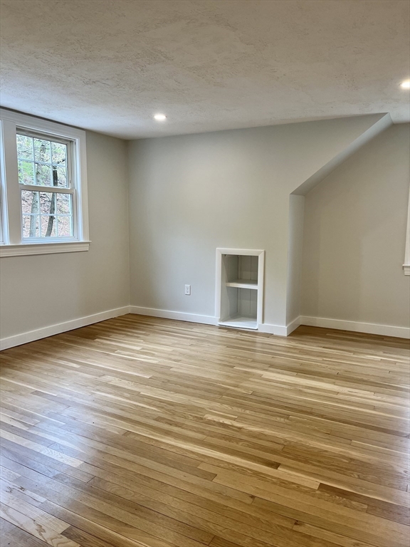69 Brookside Road Braintree, MA 02184 - Photo 17 of 28 a view of an empty room with wooden floor and a window