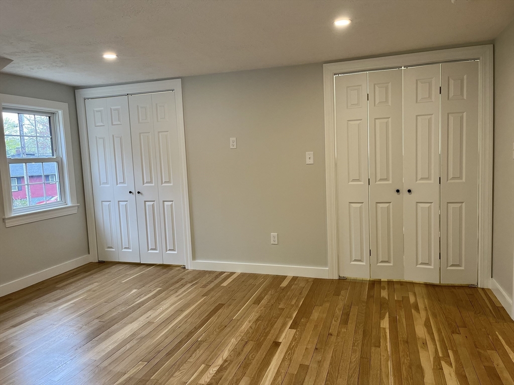 69 Brookside Road Braintree, MA 02184 - Photo 18 of 28 an empty room with wooden floor and windows
