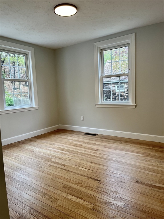 69 Brookside Road Braintree, MA 02184 - Photo 22 of 28 a view of an empty room with wooden floor and a window