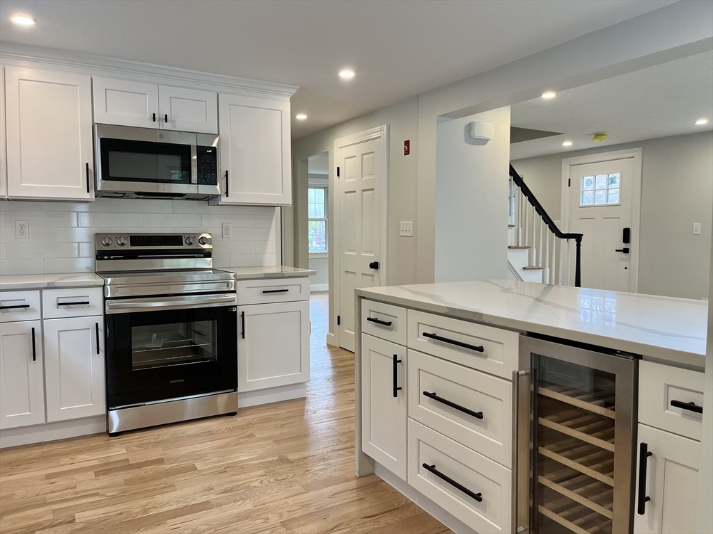 69 Brookside Road Braintree, MA 02184 - Photo 3 of 28 a kitchen with stainless steel appliances a stove microwave and cabinets