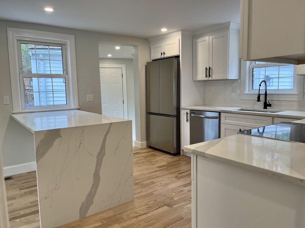 69 Brookside Road Braintree, MA 02184 - Photo 4 of 28 a kitchen with stainless steel appliances a refrigerator and a sink
