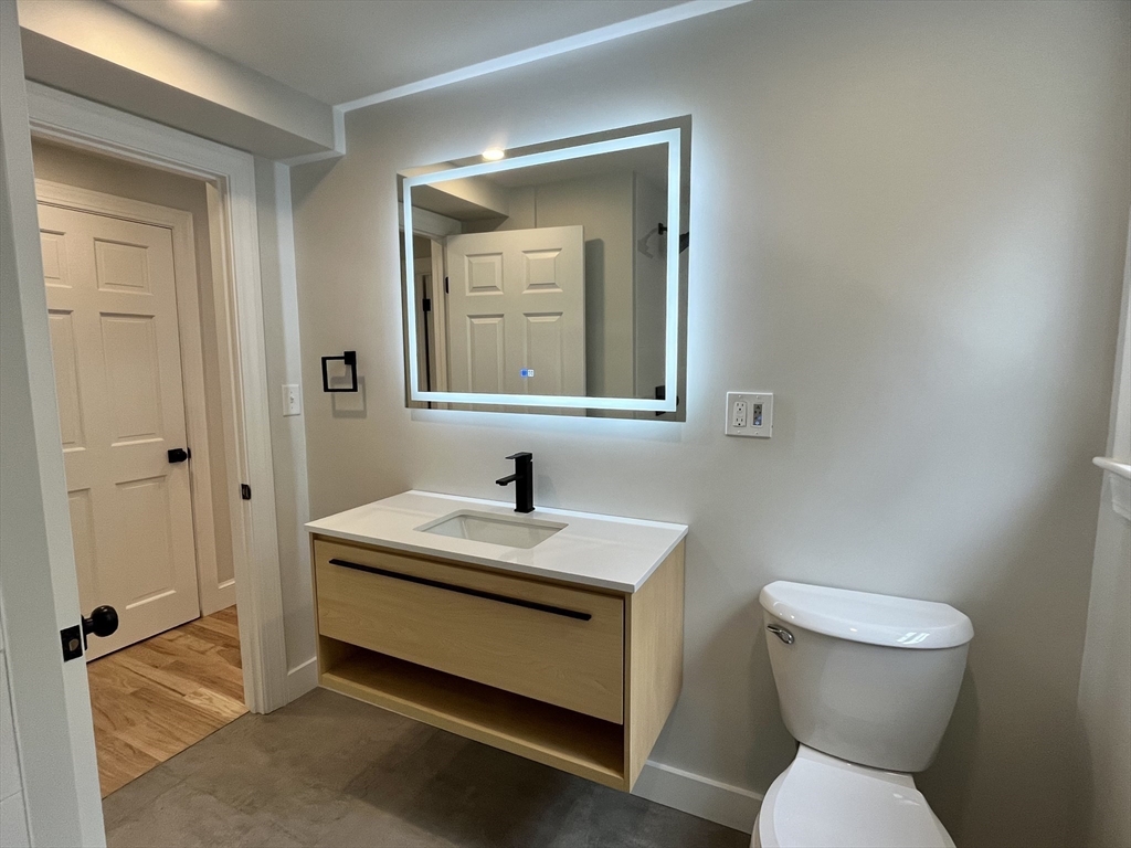 69 Brookside Road Braintree, MA 02184 - Photo 7 of 28 a bathroom with a sink a toilet and a mirror