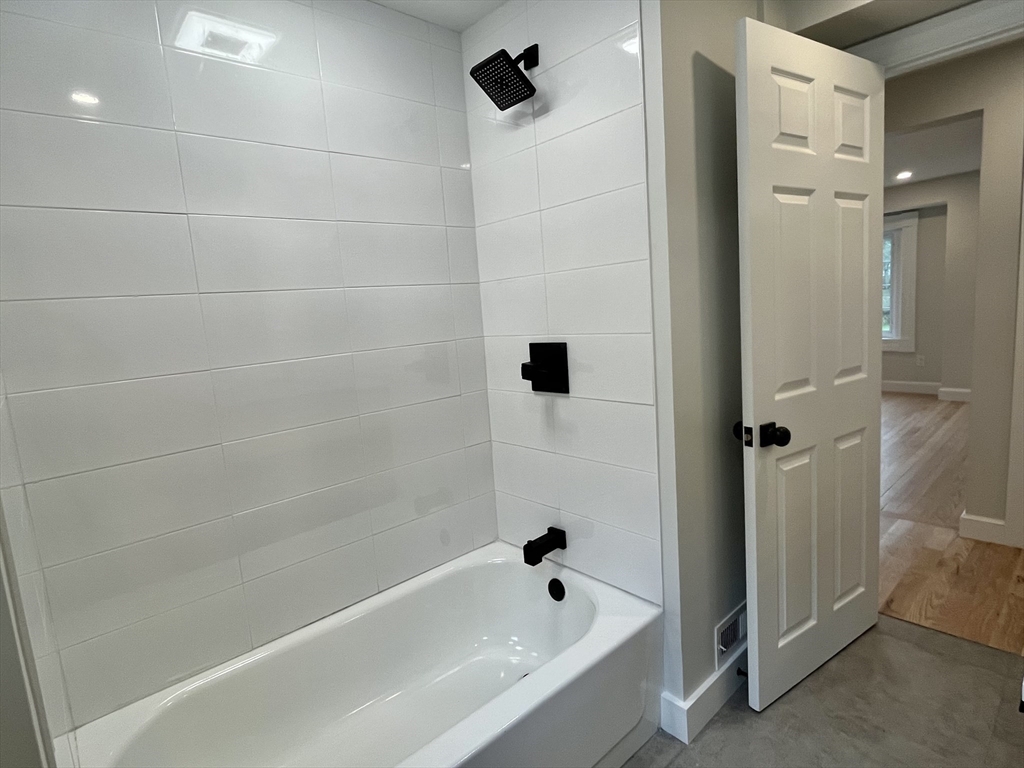 69 Brookside Road Braintree, MA 02184 - Photo 9 of 28 a bathroom with a bathtub and shower