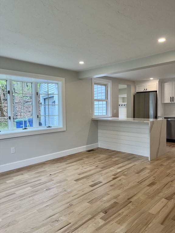 69 Brookside Road Braintree, MA 02184 - Photo 10 of 28 a view of an empty room with wooden floor and a window
