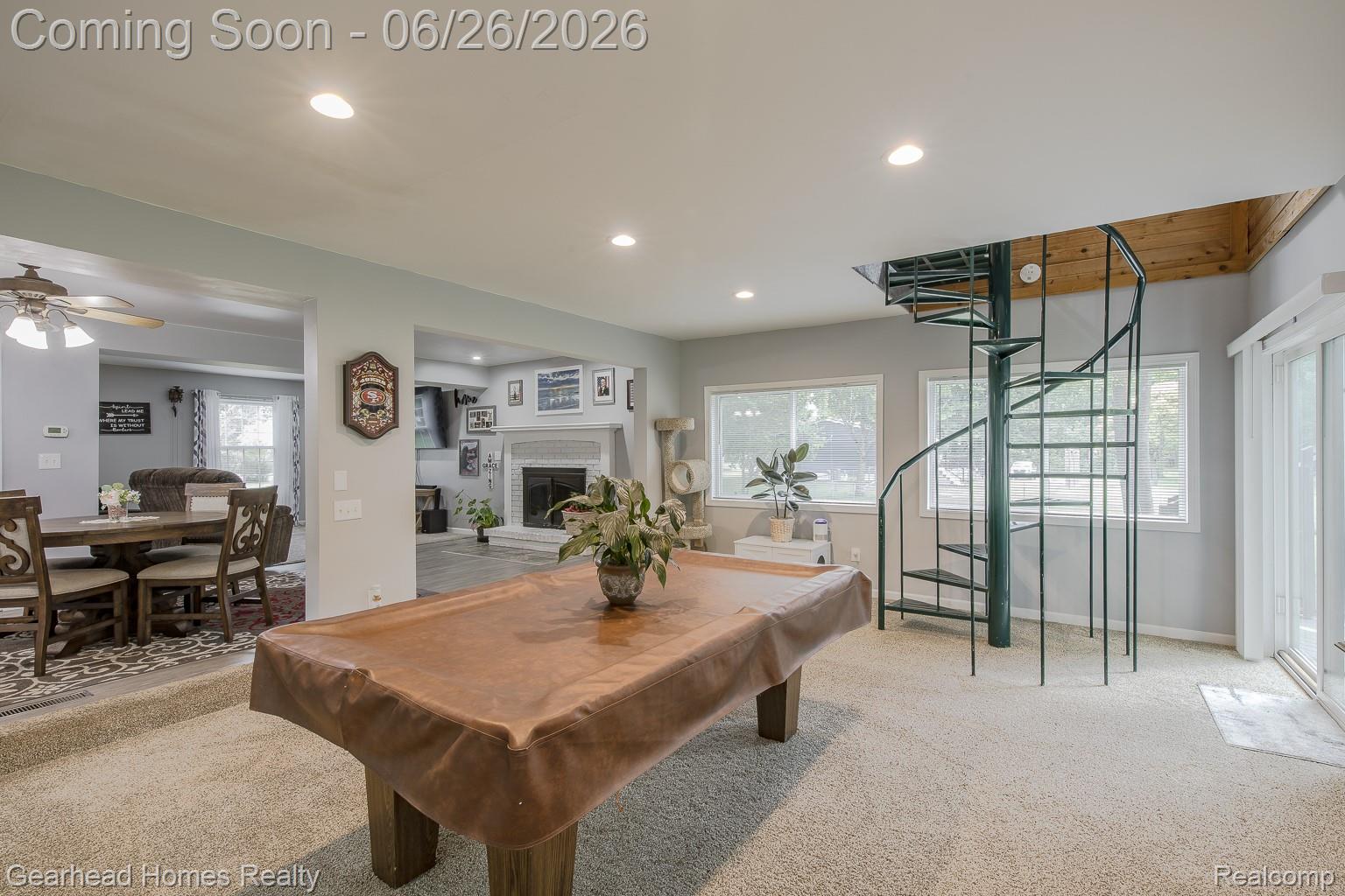 12364 Morrish Road Clio, MI 48420 - Photo 18 of 81 Carpeted recreational space featuring a spiral staircase, multiple windows, recessed lighting, and a sliding glass door