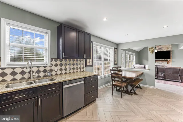 a kitchen with granite countertop sink cabinets and stainless steel appliances