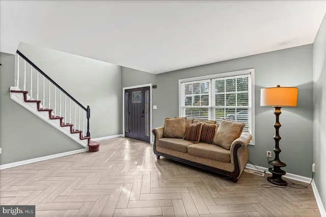 a living room with furniture and stairs