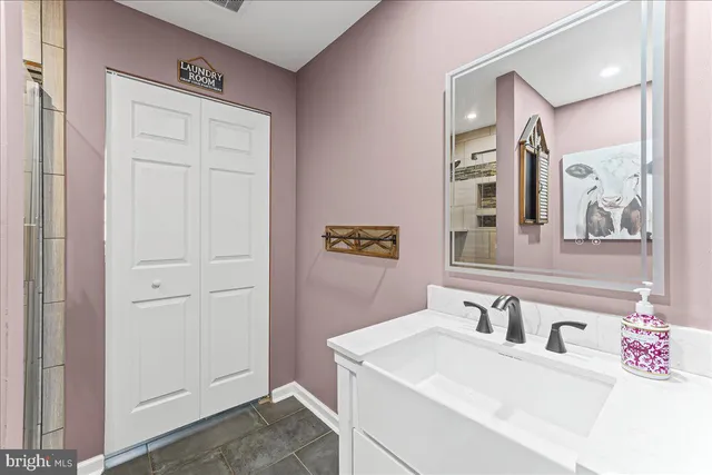 a bathroom with a sink vanity and a mirror