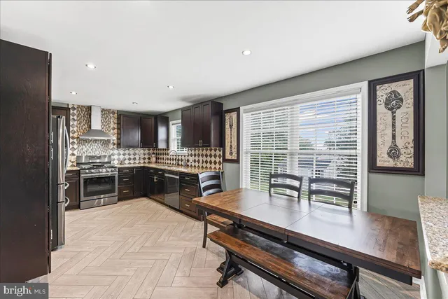 a kitchen with a table chairs sink and refrigerator