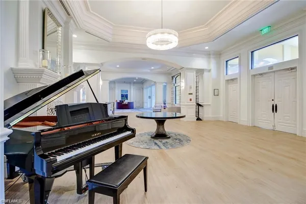 a living room with furniture and a piano