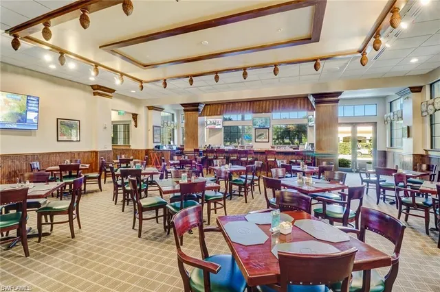 a living room with furniture a chandelier and a large window