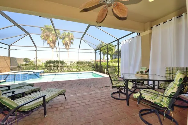 a building outdoor space with patio furniture and potted plants