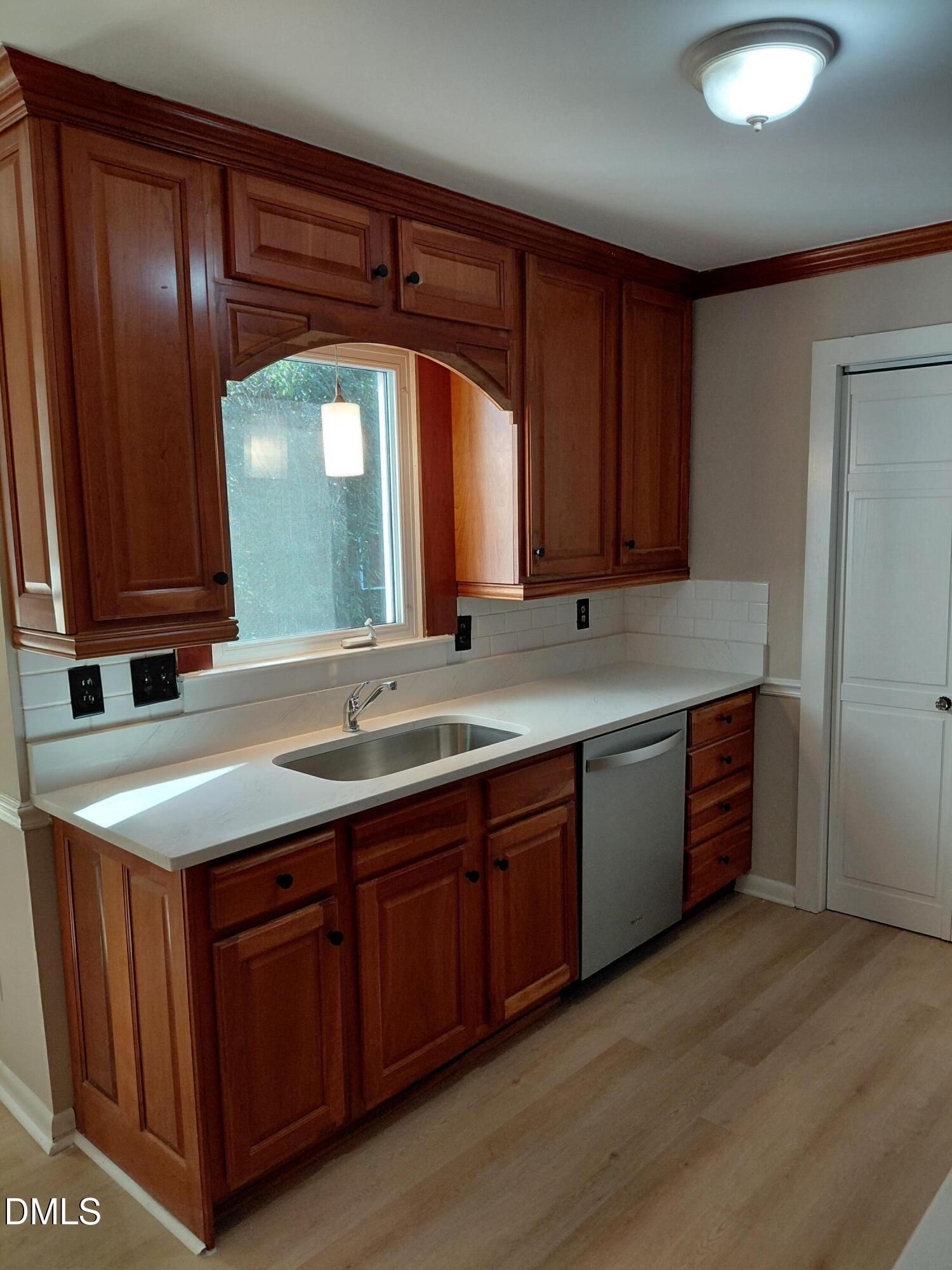 804 Olive Street Apex, NC 27502 - Photo 18 of 60 a kitchen with a sink and cabinets