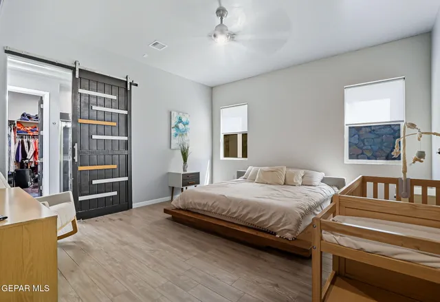 a bedroom with a bed and wooden floor