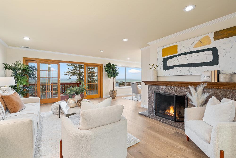 708 Morningside Drive Millbrae, CA 94030 - Photo 3 of 36 a living room with furniture a fireplace and a floor to ceiling window