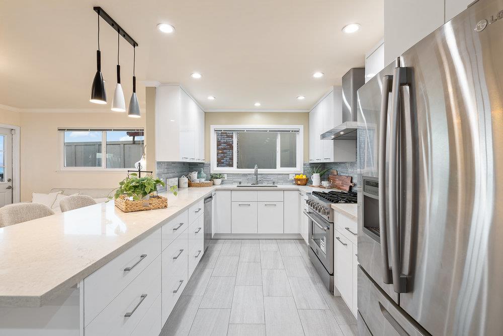 708 Morningside Drive Millbrae, CA 94030 - Photo 10 of 36 a kitchen with stainless steel appliances sink refrigerator and white cabinets