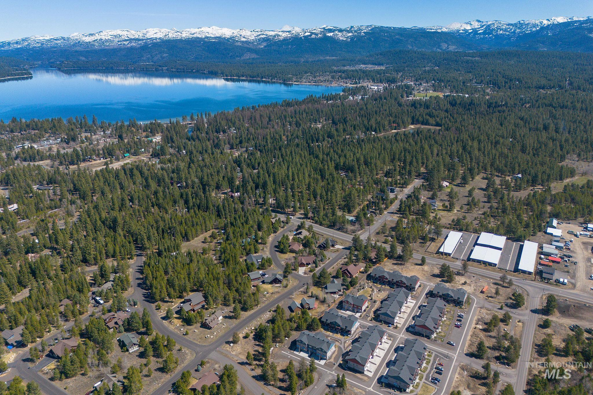311 Broken Ridge Way McCall, ID 83638 - Photo 31 of 44 Expansive aerial showcasing a large body of water, dense evergreen forests, and snow-capped mountains in the distance