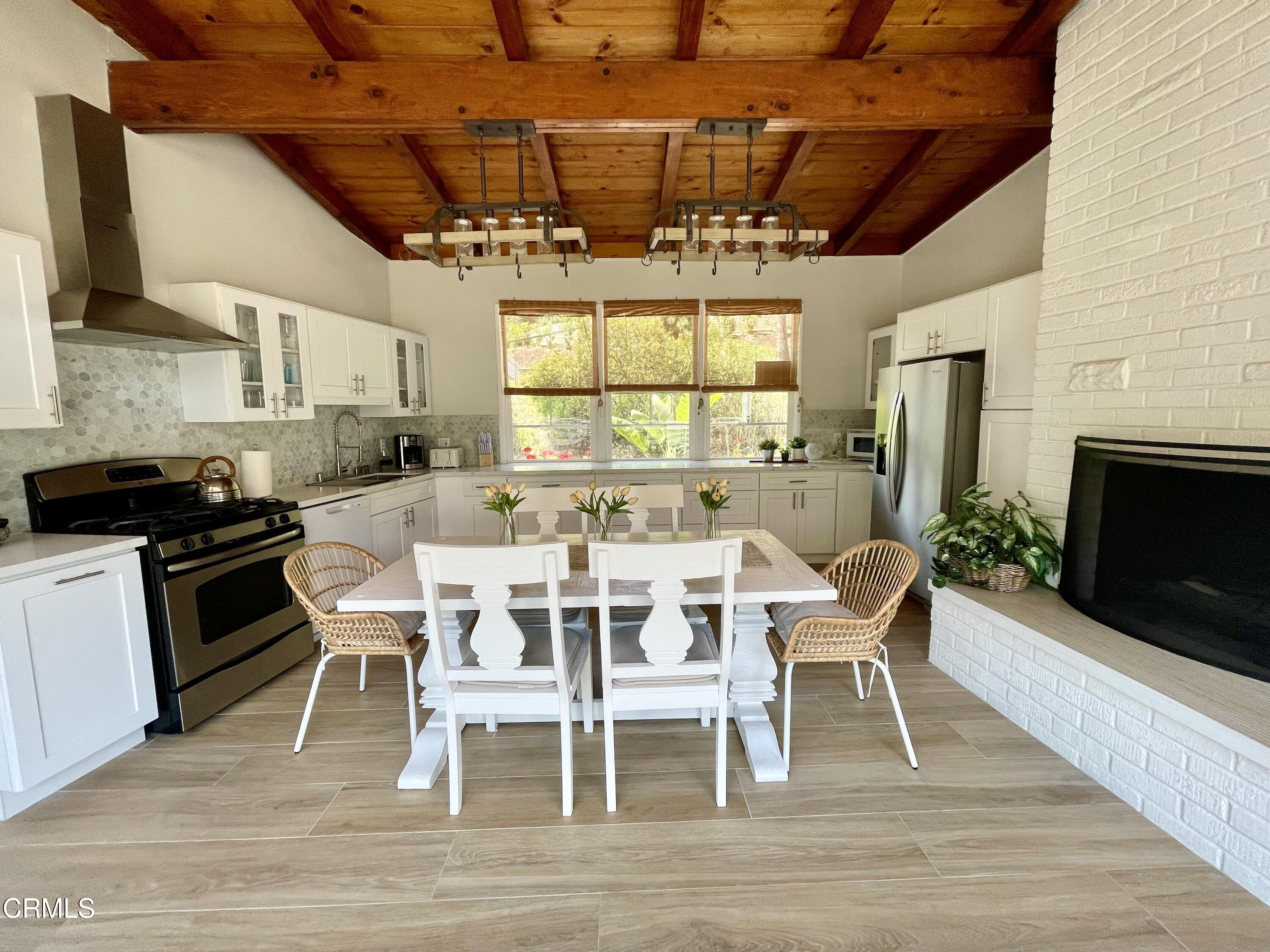 Undisclosed Address Glendale, CA 91206 - Photo 5 of 17 a dining room with furniture a fireplace and wooden floor
