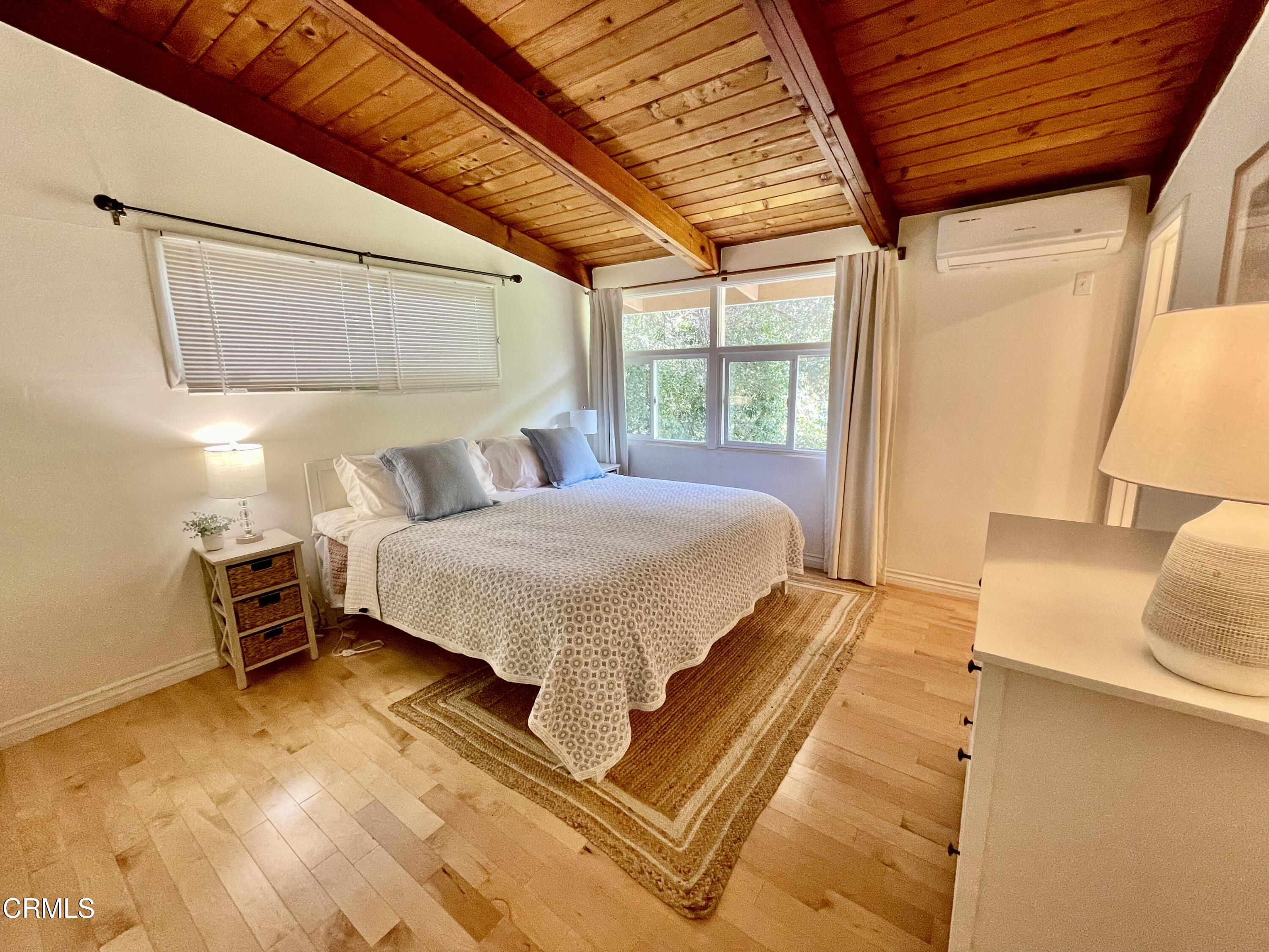 Undisclosed Address Glendale, CA 91206 - Photo 8 of 17 a bedroom with a bed and wooden floor