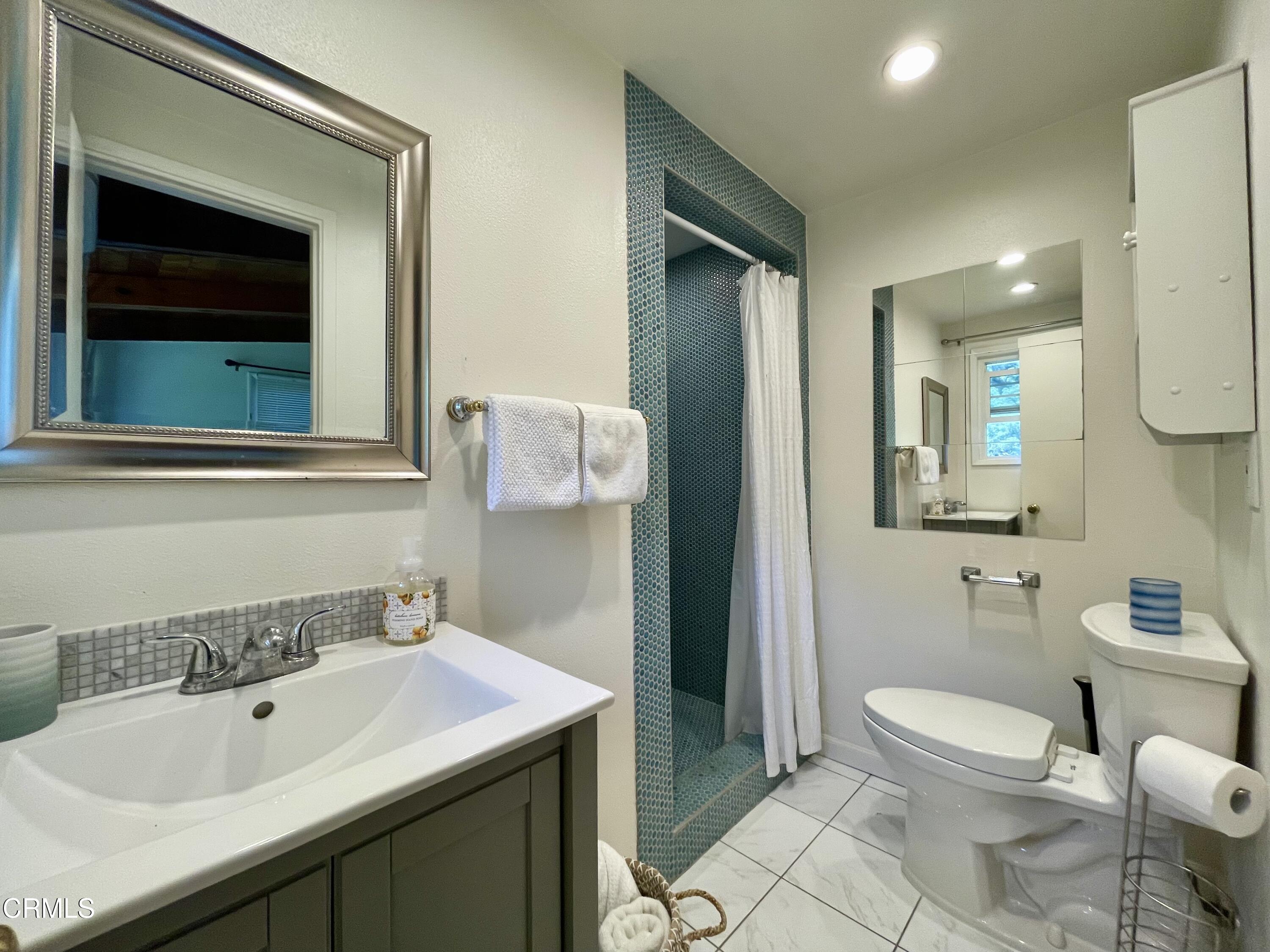 Undisclosed Address Glendale, CA 91206 - Photo 9 of 17 a bathroom with a toilet sink and mirror