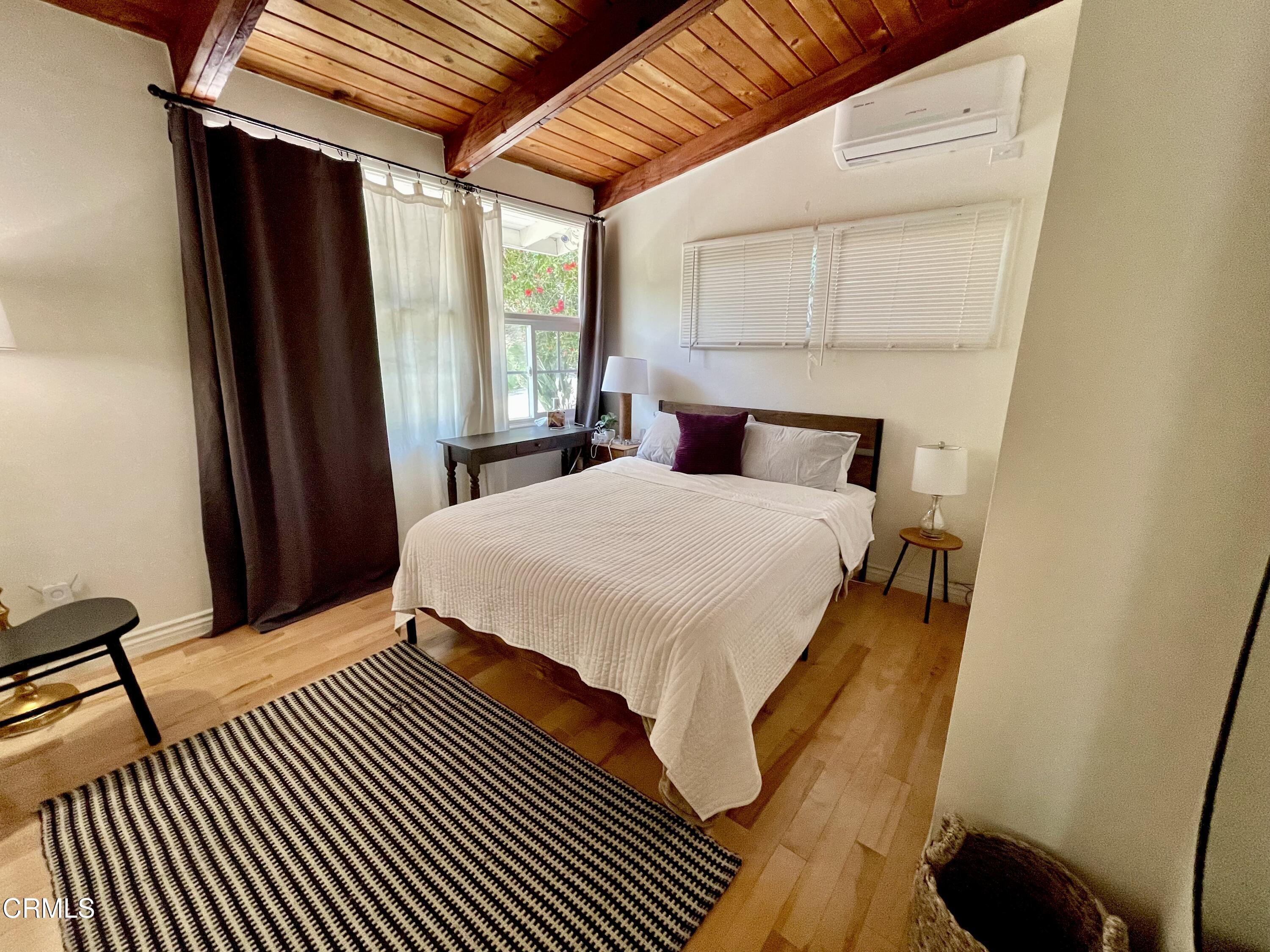 Undisclosed Address Glendale, CA 91206 - Photo 10 of 17 a bedroom with a bed and a mirror