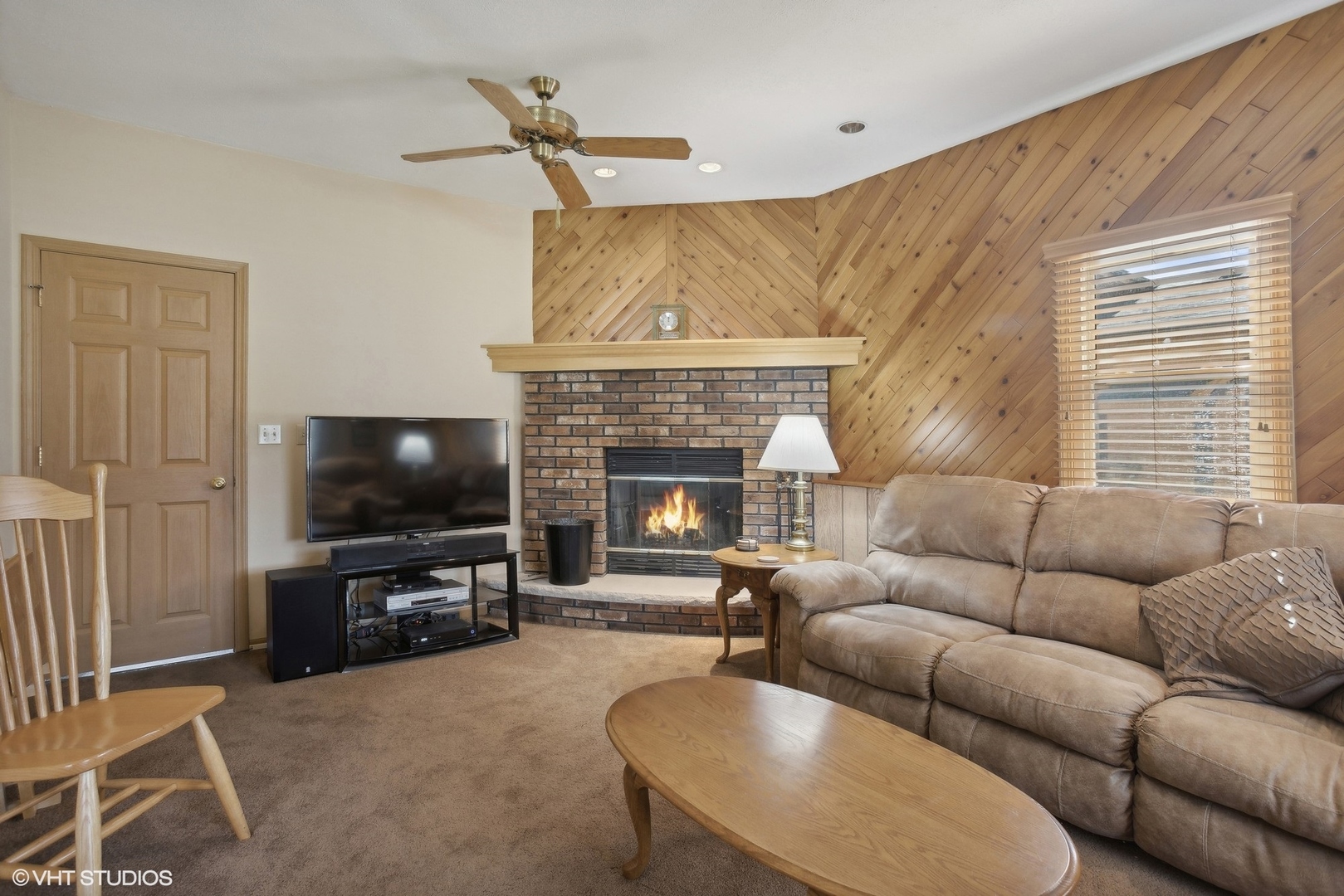 704 Stonegate Road New Lenox, IL 60451 - Photo 6 of 22 a living room with furniture a flat screen tv and a fireplace