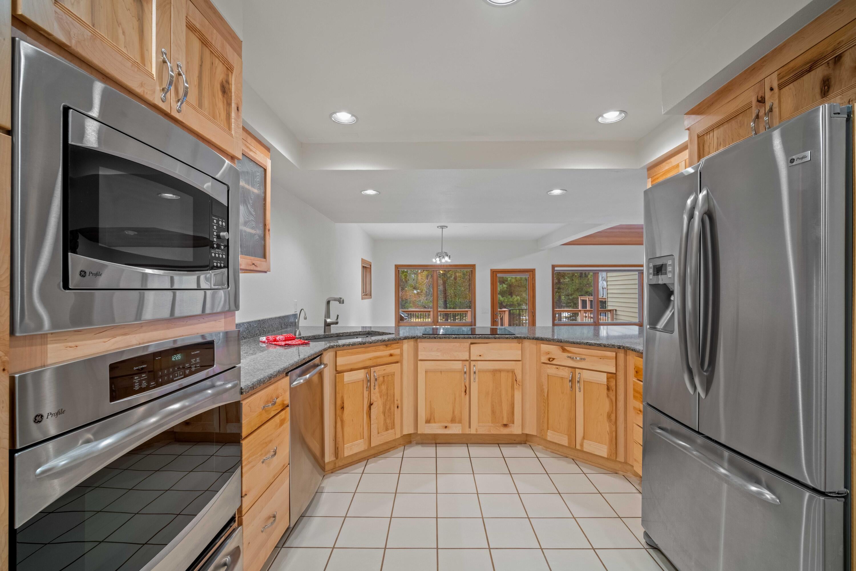 17674 Bittern Lane, Unit 7 Sunriver, OR 97707 - Photo 11 of 43 Spacious kitchen with granite counters and custom cabinetry. View of the river from the kitchen.
