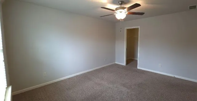 a view of an empty room with a fireplace