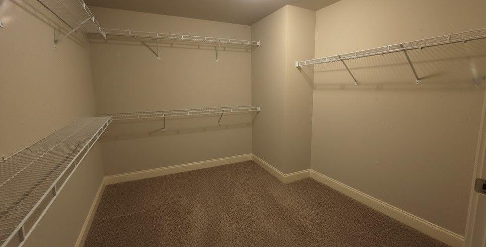 4191 Towncastle Lane Buford, GA 30518 - Photo 16 of 21 a view of a room with racks on the wall