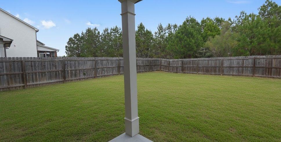 4191 Towncastle Lane Buford, GA 30518 - Photo 20 of 21 a view of a backyard with a small yard and wooden fence
