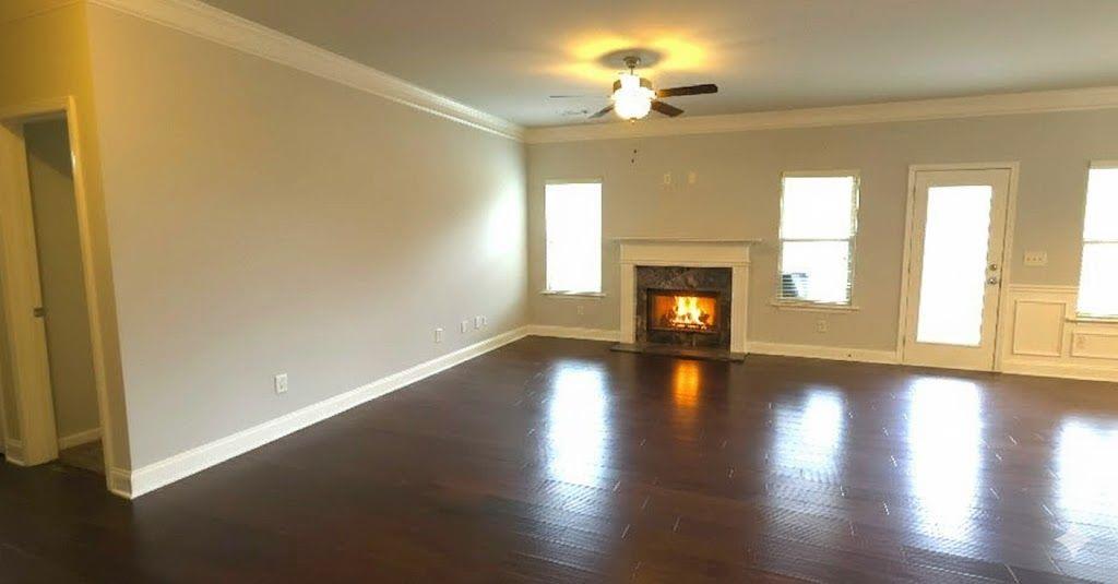 4191 Towncastle Lane Buford, GA 30518 - Photo 3 of 21 a view of an empty room with wooden floor and a window