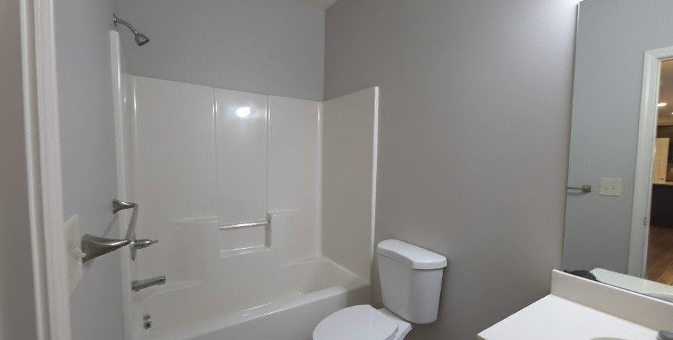 4191 Towncastle Lane Buford, GA 30518 - Photo 10 of 21 a bathroom with a toilet and a shower